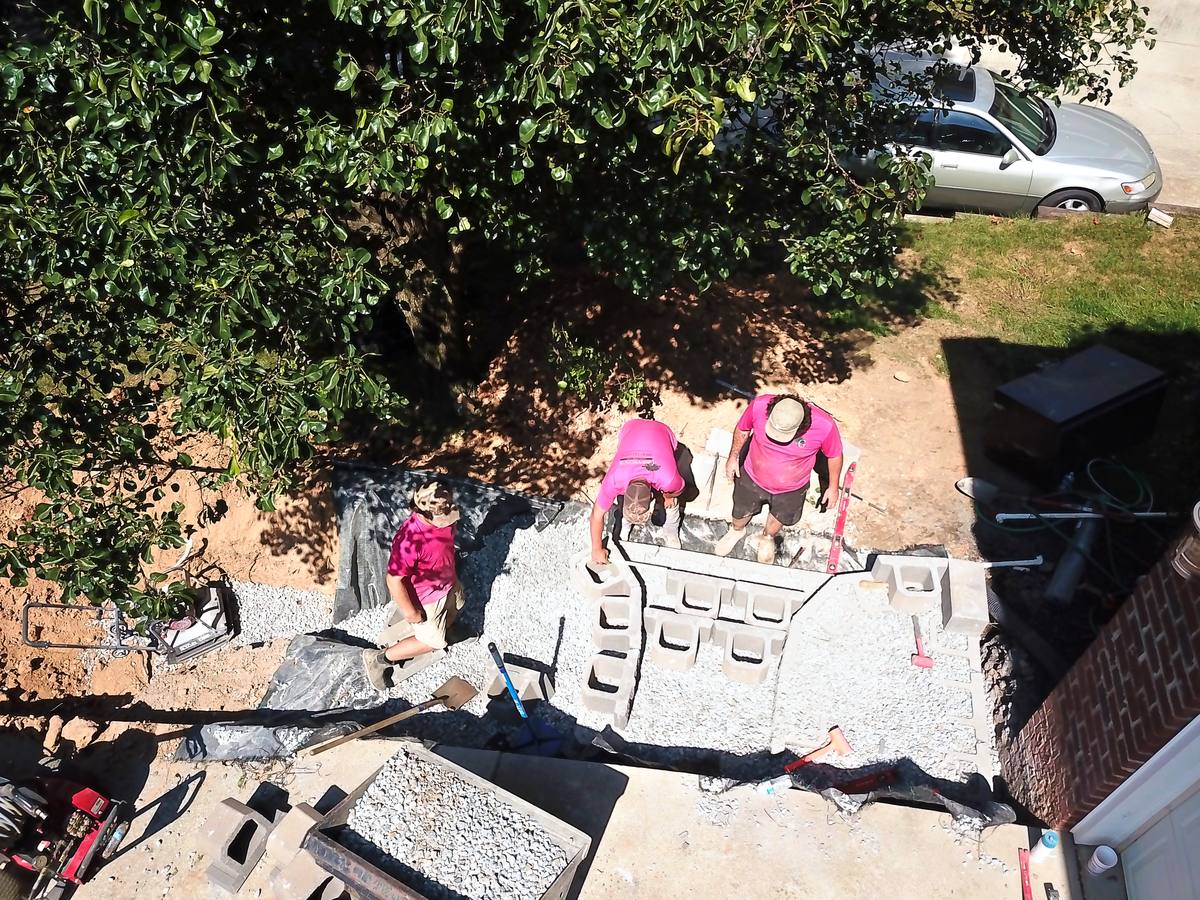The crew setting retaining wall block, seen from above.